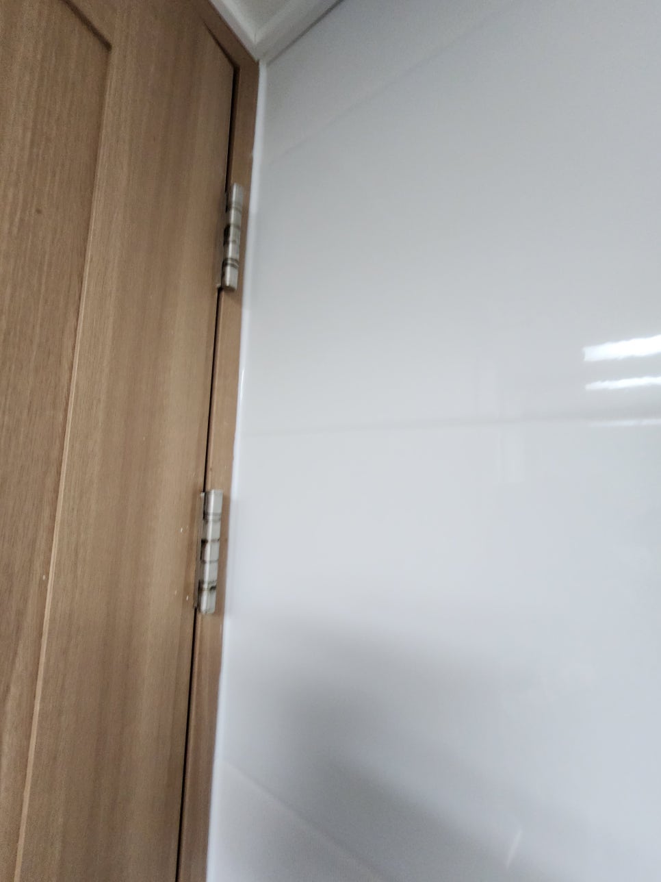 교체한 수건걸이와 정리된 흰색 욕실 벽타일