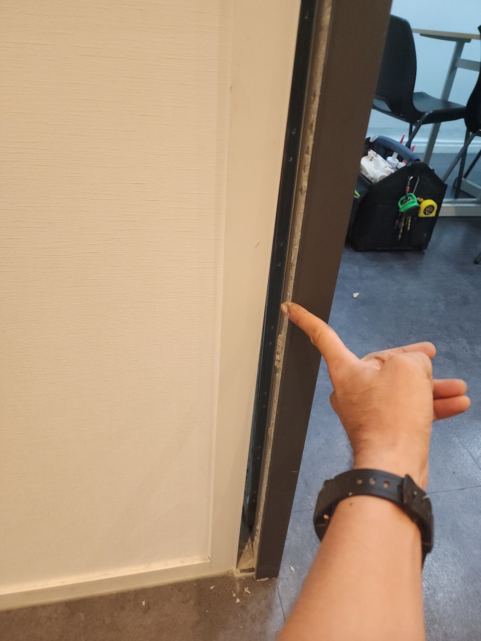 문틀과 벽체 사이의 분리된 틈을 가리키는 모습
